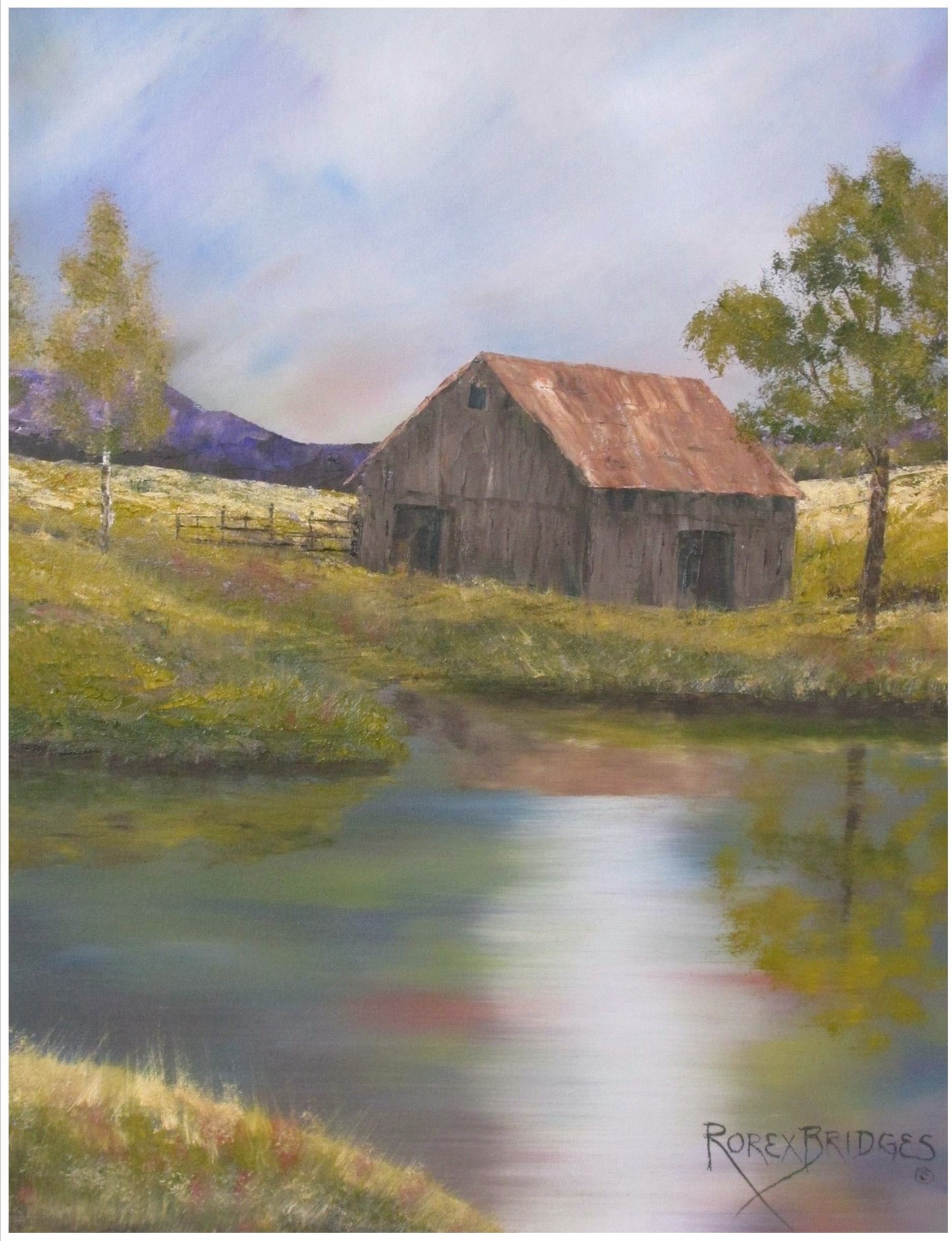 little old barn beside a pond in a valley surrounded by mountains